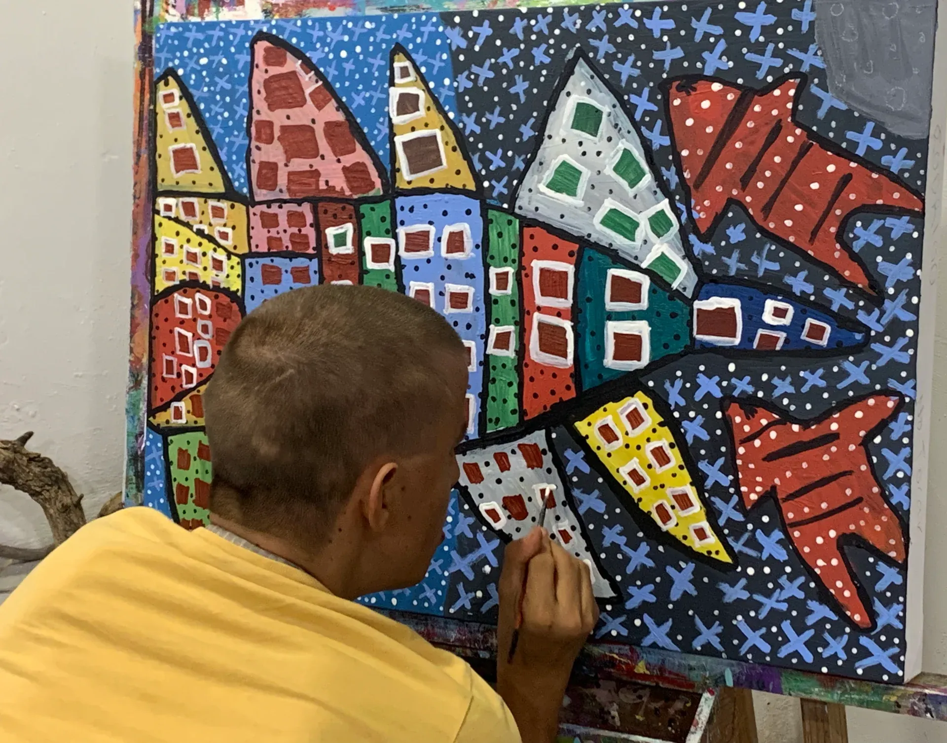 Young student painting a colorful abstract piece